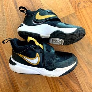 Boys Nike basketball shoes in gold and black with cross over strap, size 12.